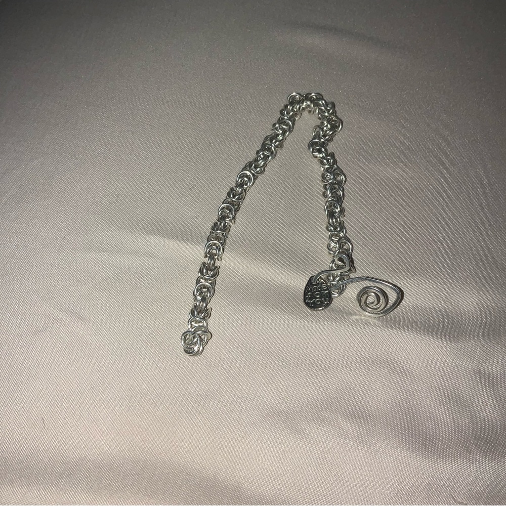 STERLING SILVER inscribed bracelet.  7in.  Need to repair an keep closed.